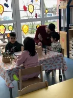 Vater im Kindergarten spielt mit seinen Kindern