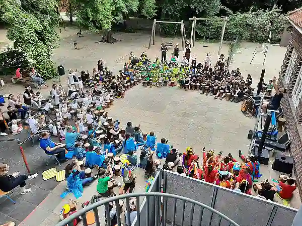 Kinder mit Trommeln sitzen in einen großen Kreis